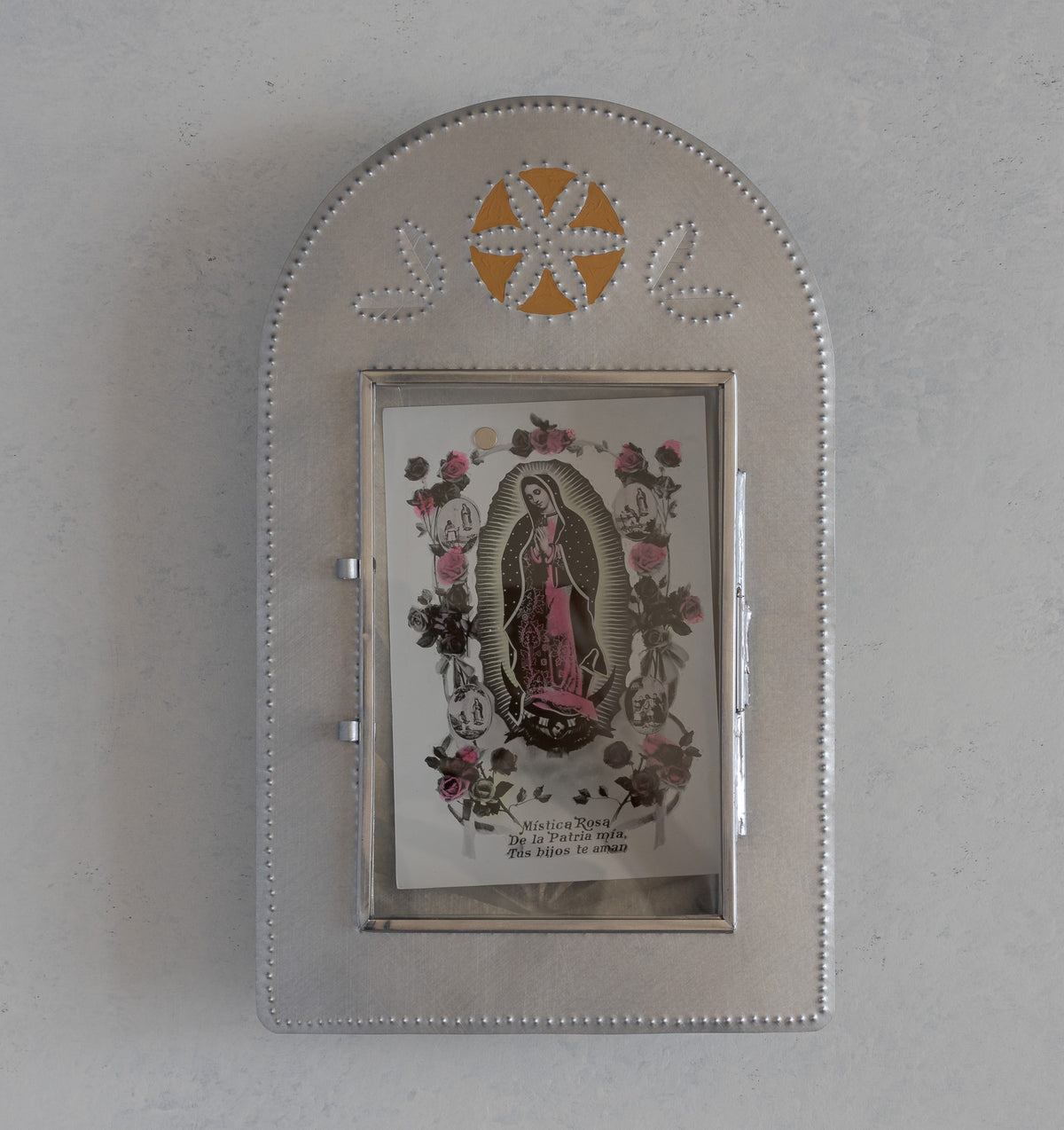 Nicho de Recuerdo in ochre painted finish, glass door open, holding a Virgen de Guadalupe devotional card, handmade in Santa Fe