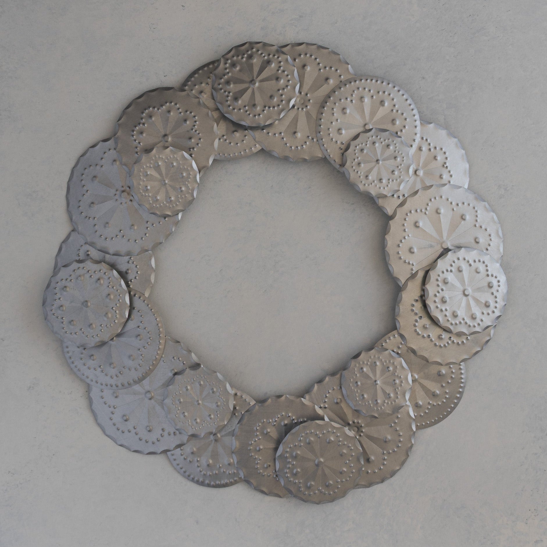 Tin Roseta Corona wreath made of 23 hand punched rosettes, handmade in Santa Fe