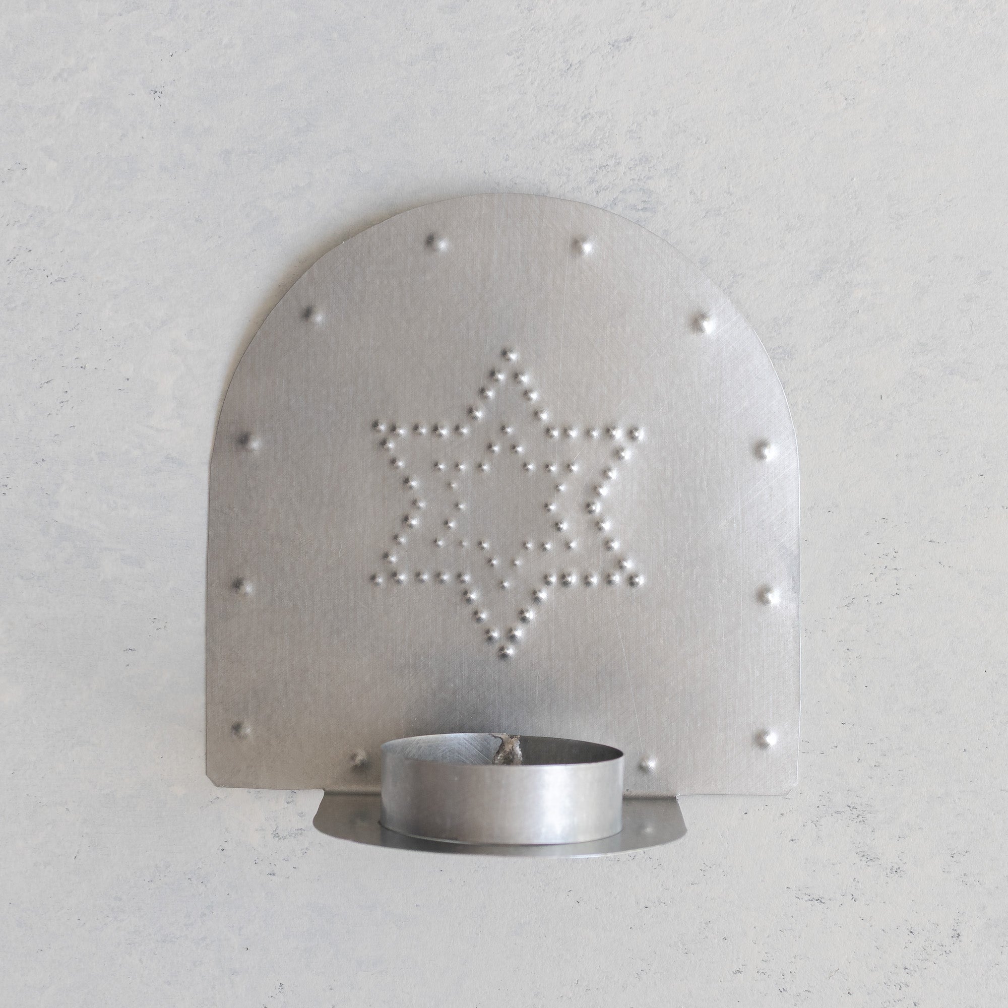 Hand-punched tin tealight candleholder with a Star of David (Magen David) design, wall mounted