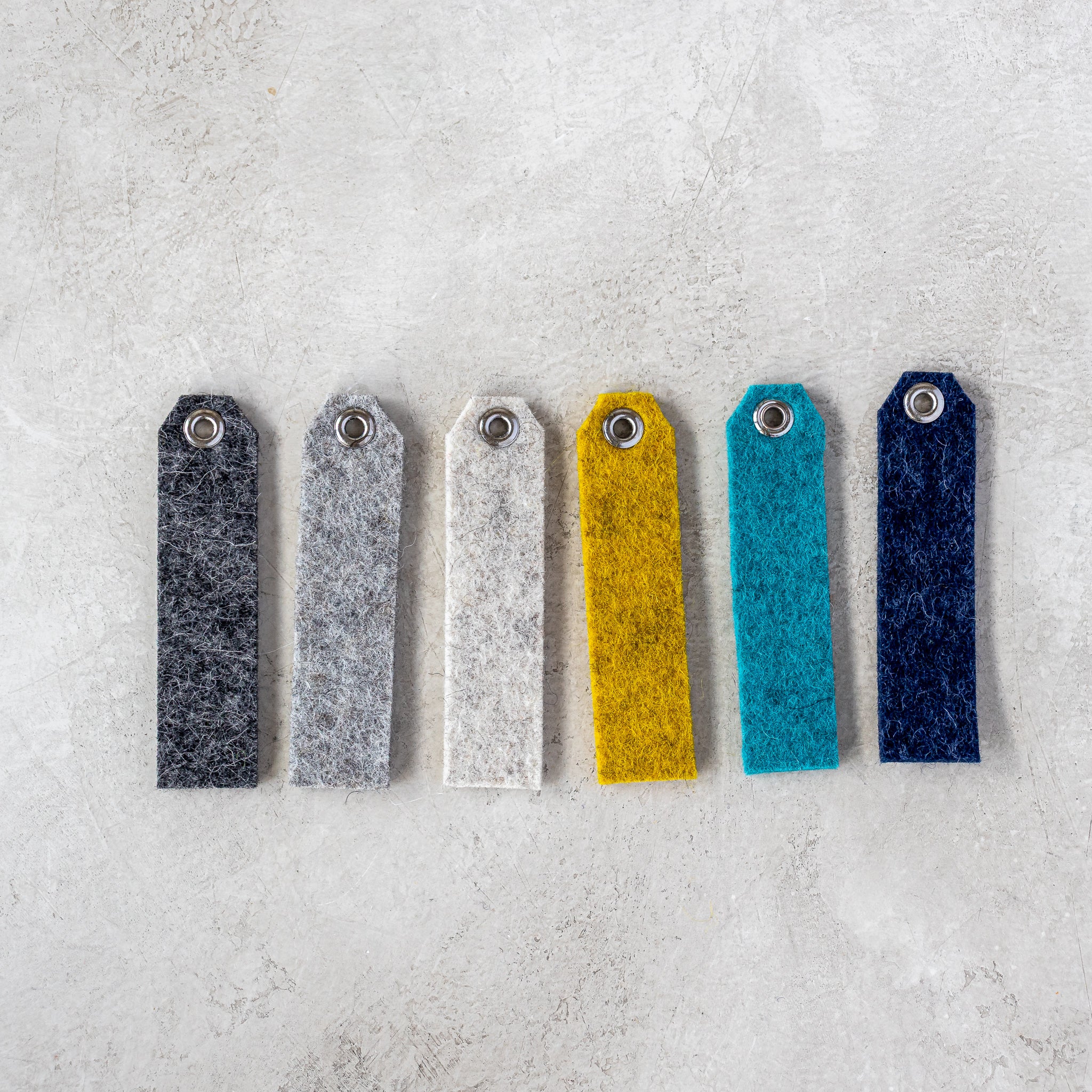 Set of six felt tag color options for the Accent Oval Key Ring, displayed side by side.
