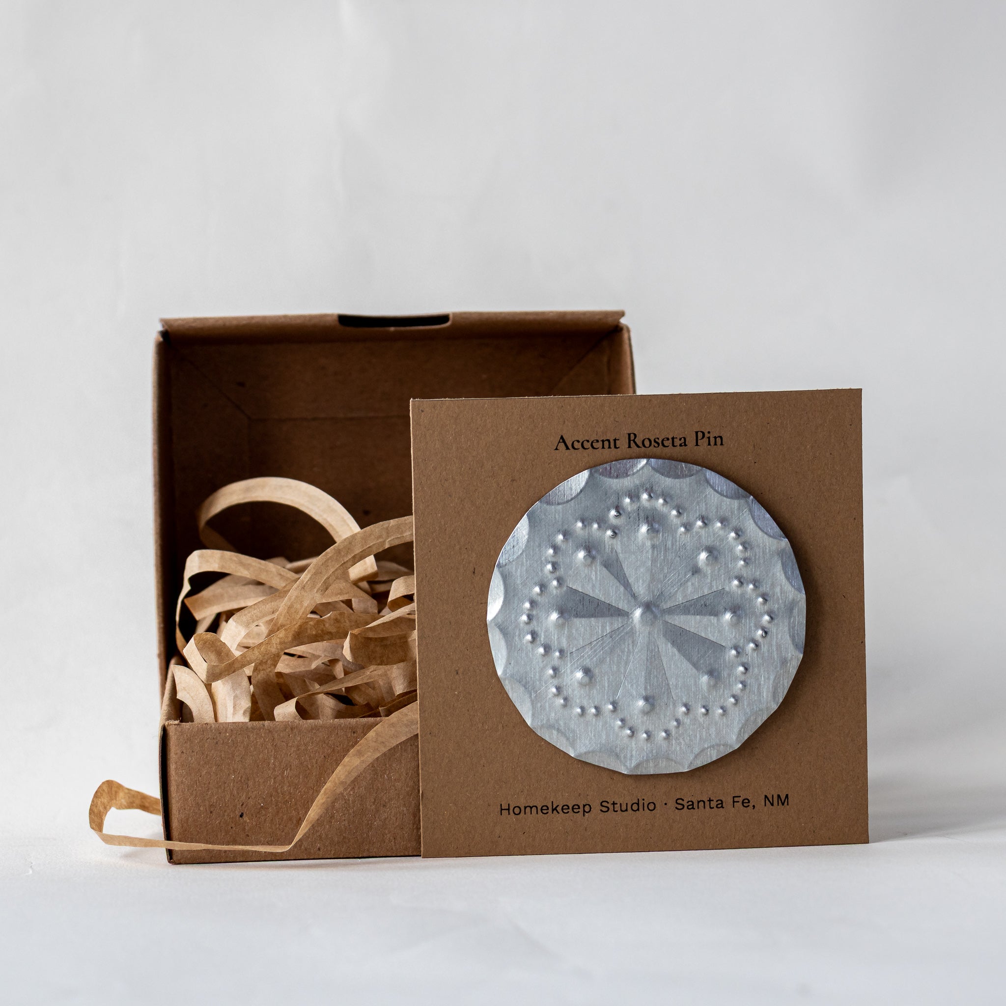 Accent Roseta Pin displayed on kraft backing card with gift box and paper fill.