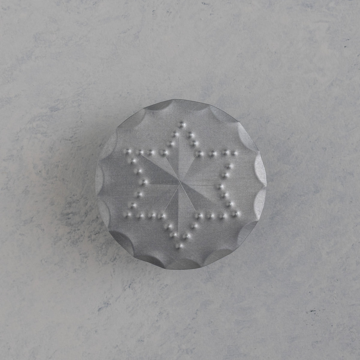 Hand punched tin bandana slide with scalloped edge and six point star motif, handmade in Santa Fe