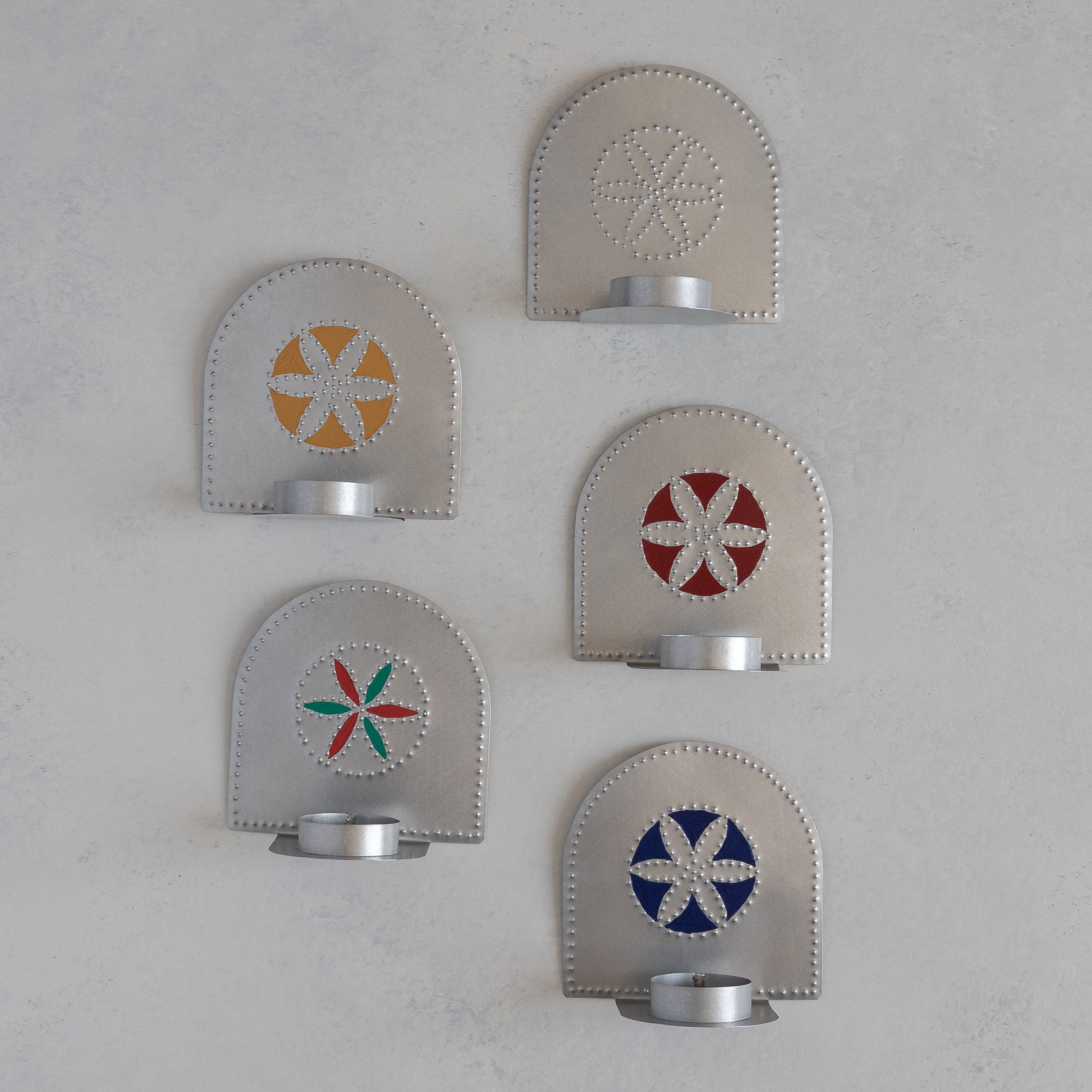 Tin flor tealight candleholders in five colorways, Ochre, Wine, green and red, Prussian Blue, and plain silver, handmade in Santa Fe