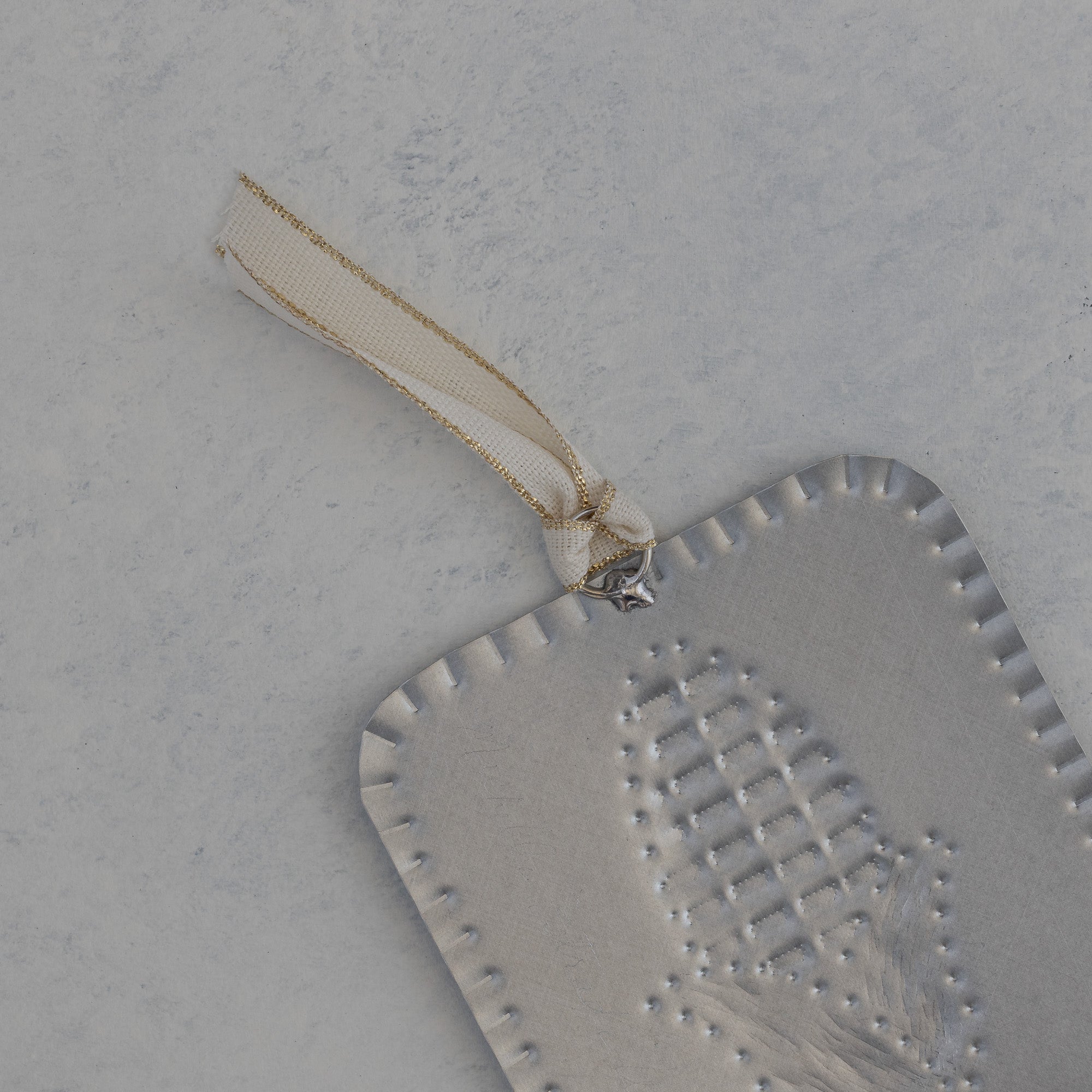 Back of the Maize Milagro showing scalloped edge and gold trimmed ivory ribbon