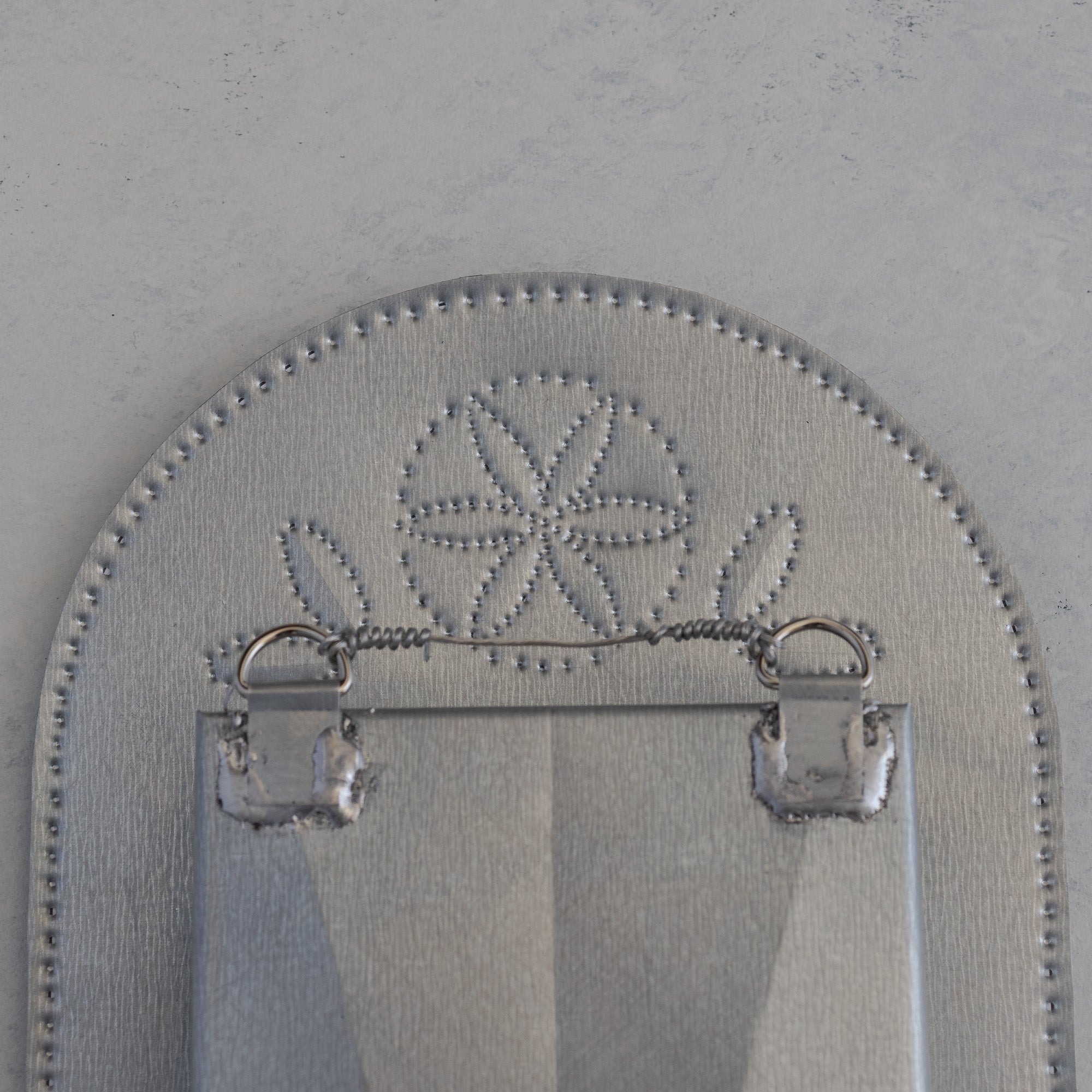 Back of the Nicho de Recuerdo showing hanging tabs and floral punch detail, handmade in Santa Fe