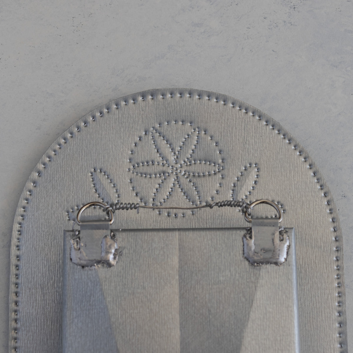 Back of the Nicho de Recuerdo showing hanging tabs and floral punch detail, handmade in Santa Fe
