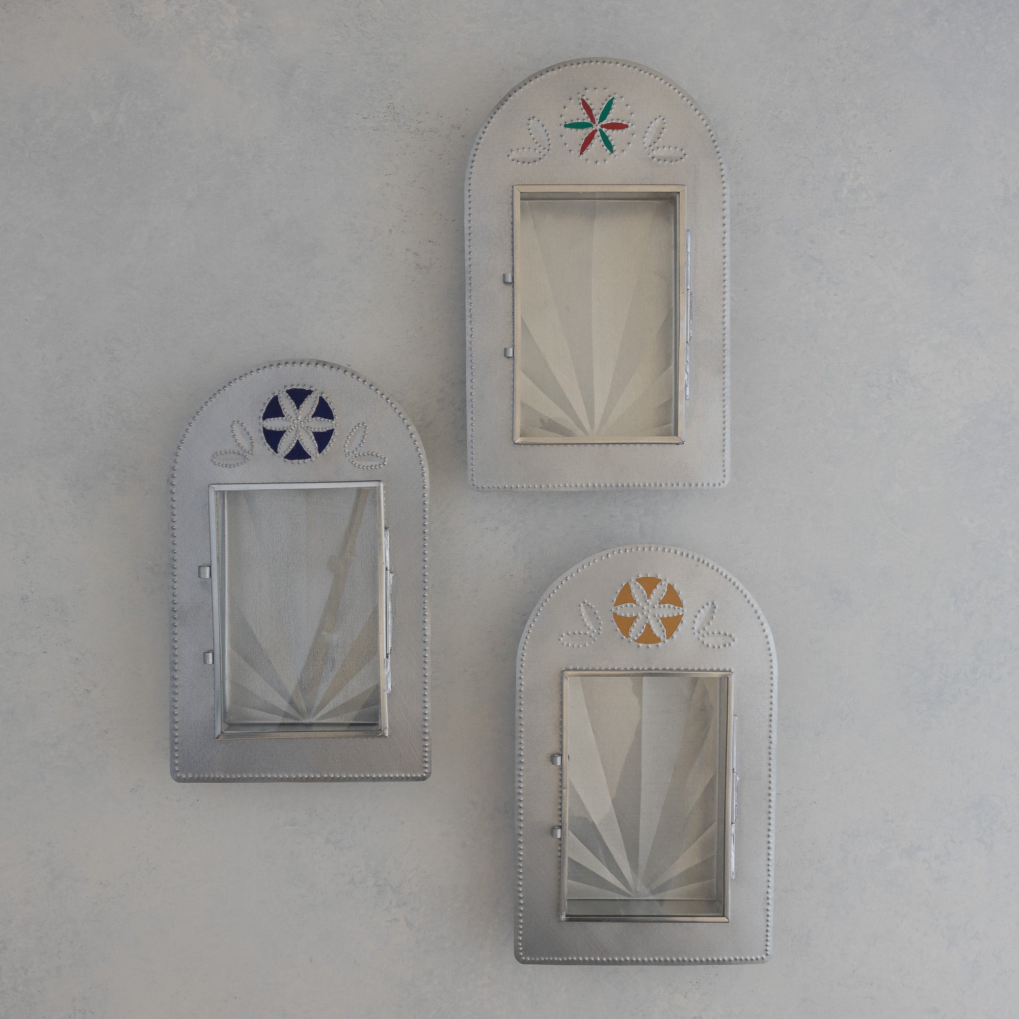 Three Nicho de Recuerdo shadow boxes in red and green, Prussian blue, and ochre painted finishes, doors open, handmade in Santa Fe