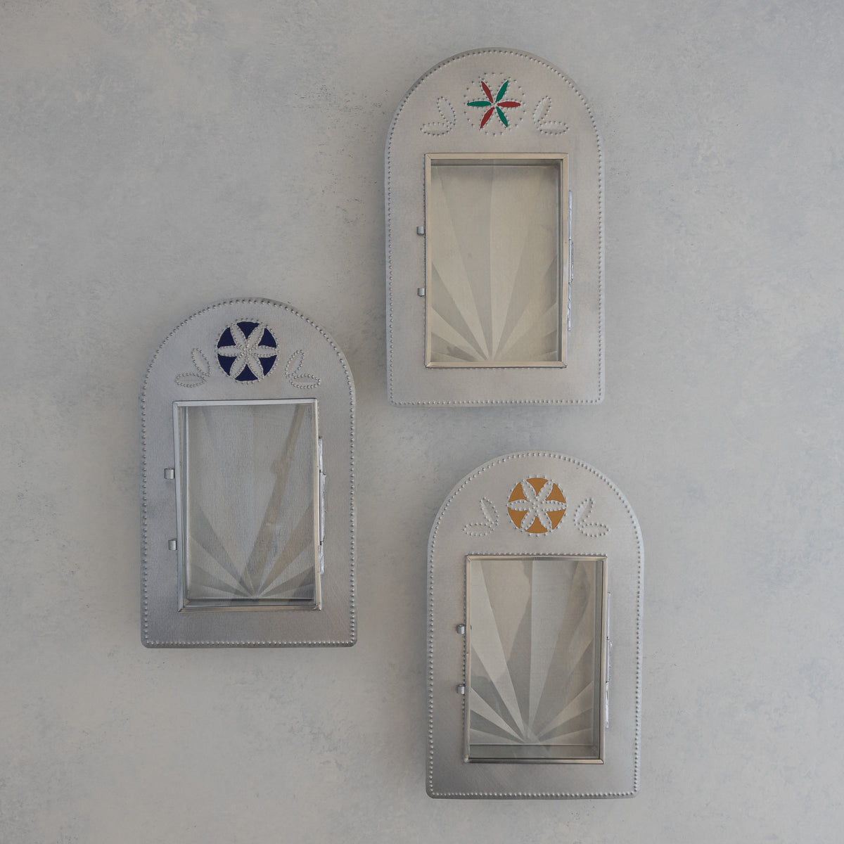 Three Nicho de Recuerdo shadow boxes in red and green, Prussian blue, and ochre painted finishes, doors open, handmade in Santa Fe