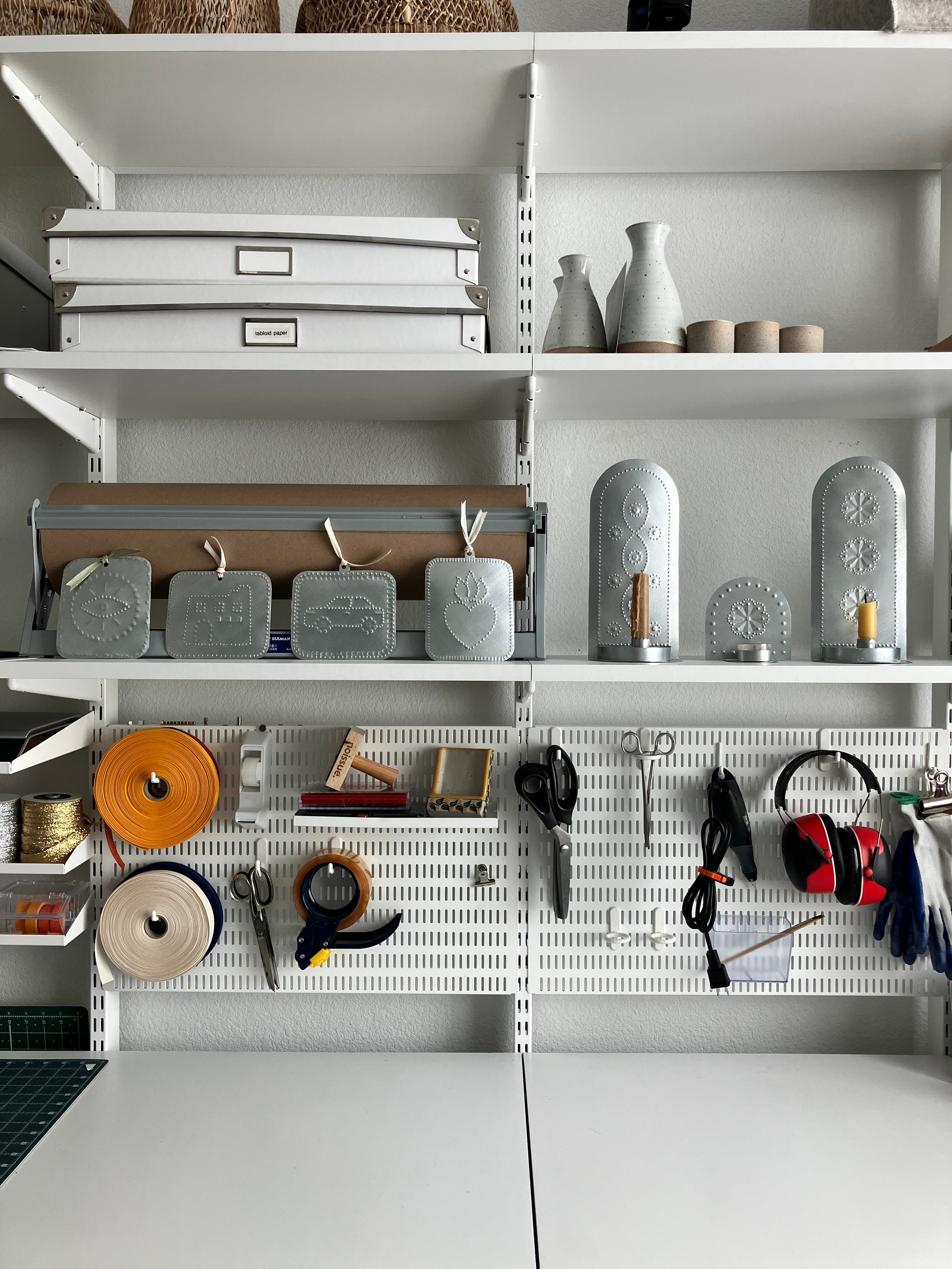 Homekeep Studio workspace shelves with tinwork and tools