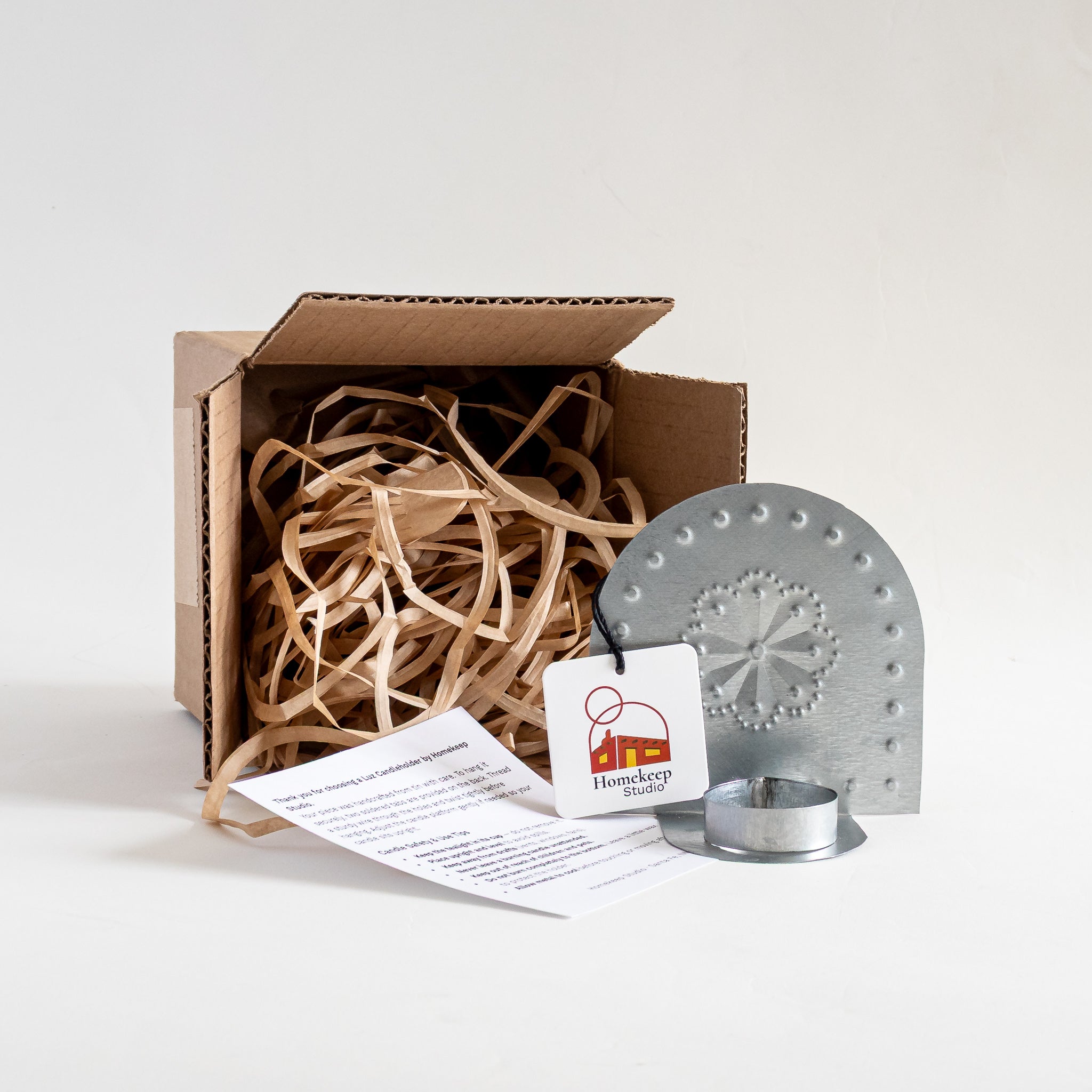  Roseta Tealight Holder tin candleholder packaged in kraft box with paper fill and care card.