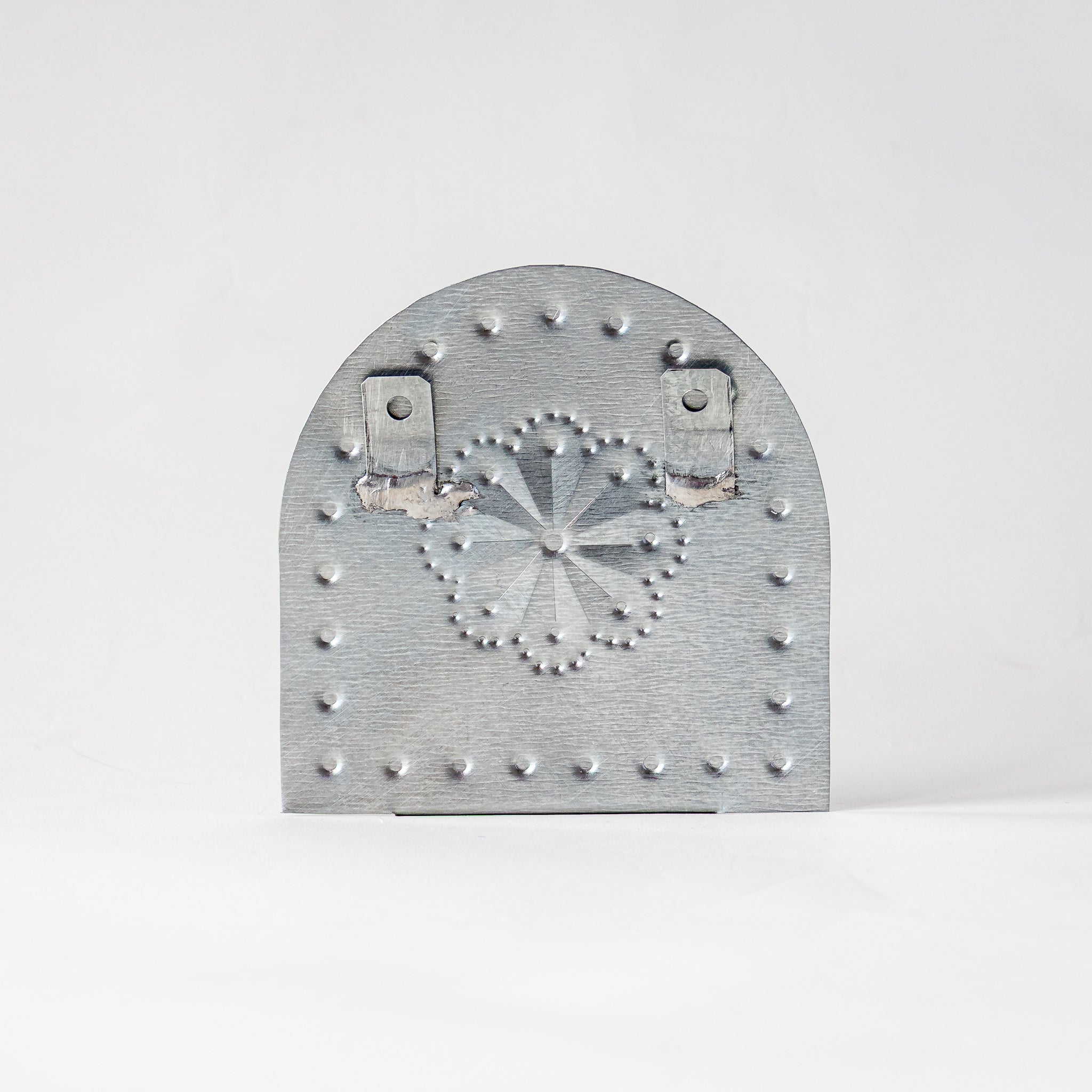 Back view of Luz Roseta Tealight Holder with soldered hanging tabs for wall display.