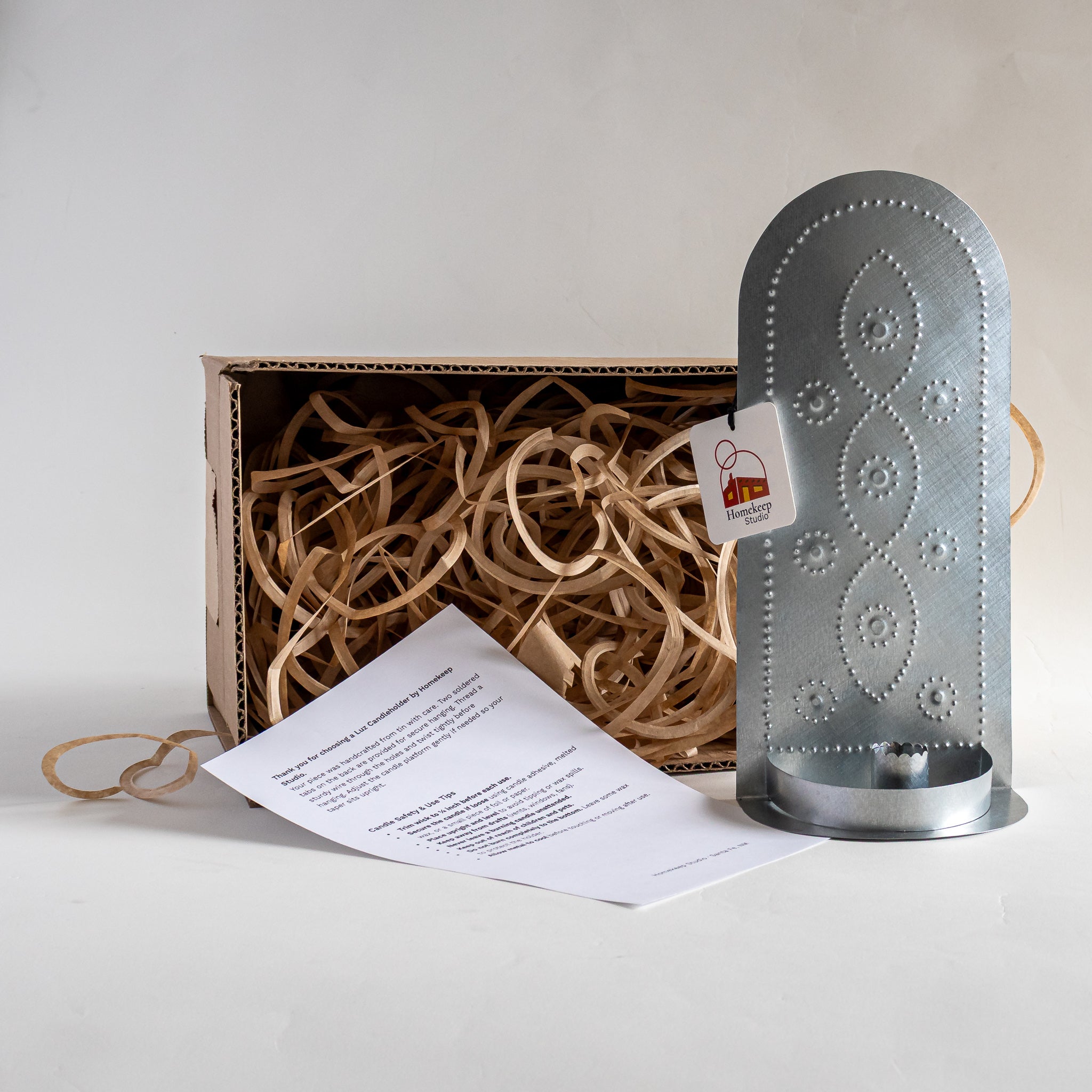 Vine Taper Holder tin candleholder packaged in kraft box with paper fill and care card.