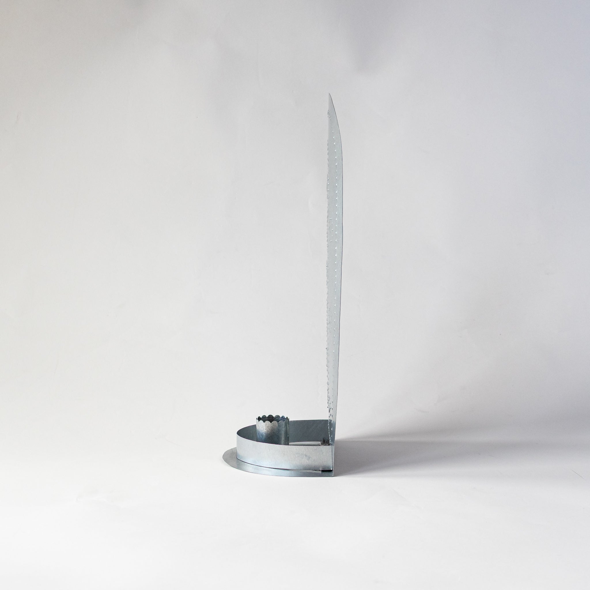 Side profile of the Roseta Trio Taper Holder, showing slim tin construction and candle cup.