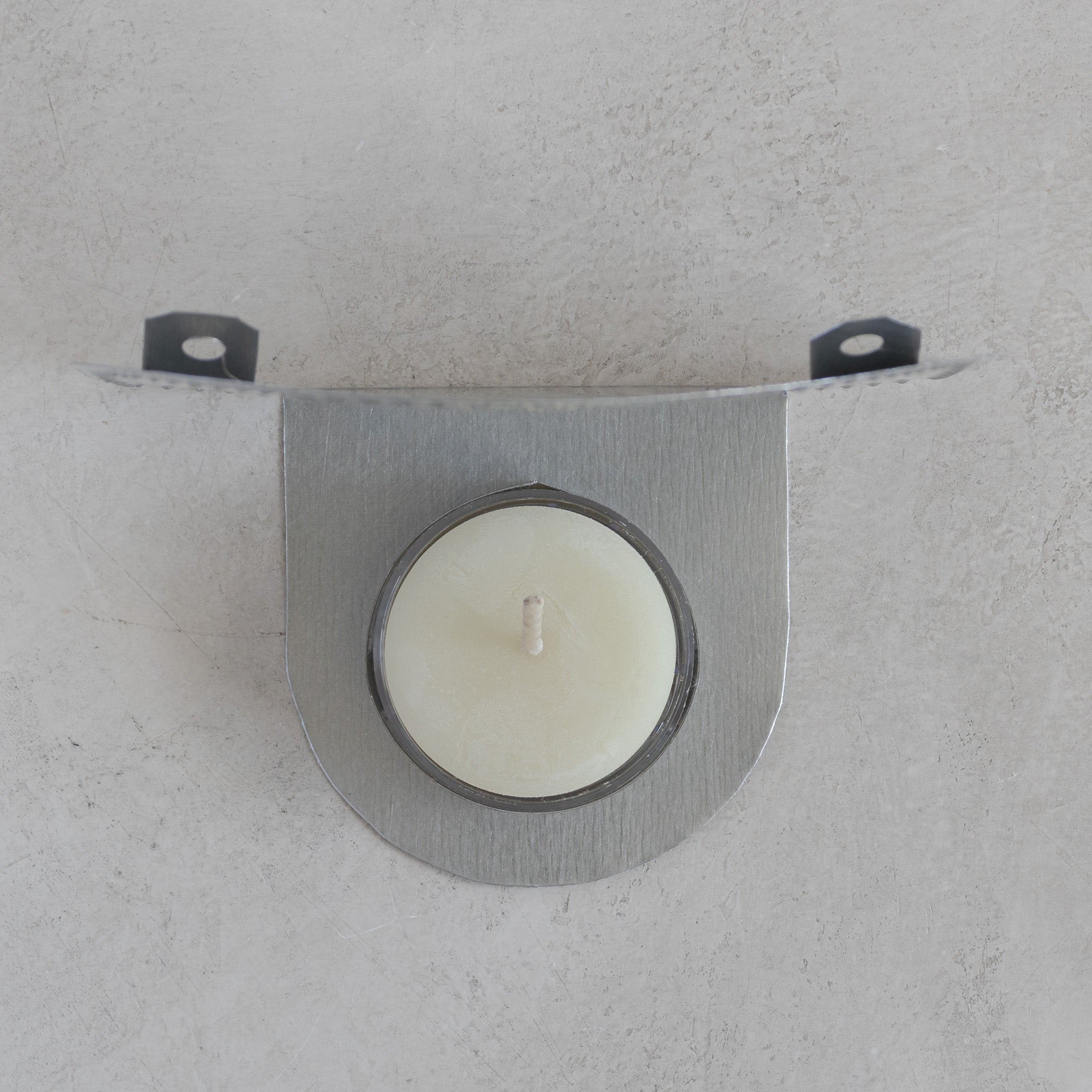 Top view of flor tealight candleholder showing candle cup and tin construction
